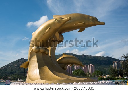 Hong Kong, China - 25 May 2014 : great gold dolphin sculpture on the Gold Coast Dolphin Square, Tuen Mun