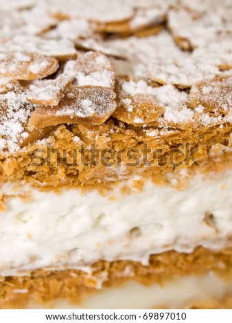 Cake almond with whipped cream and cream isolated on white close-up