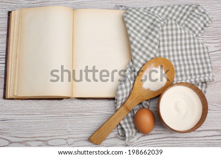 Cooking concept. Ingredients and kitchen tools with the old blank recipe book
