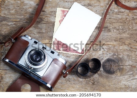 old camera and old pictures  on wooden table, old memories