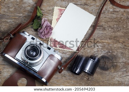 old camera and old pictures  on wooden table, old memories