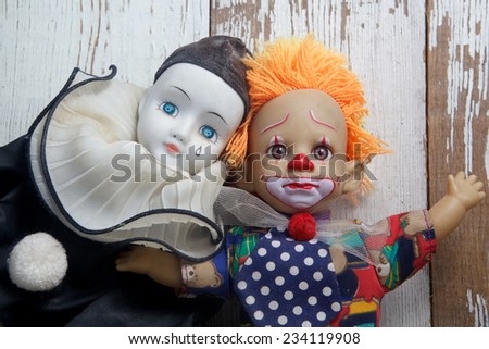 Sad old vintage dolls on wooden background