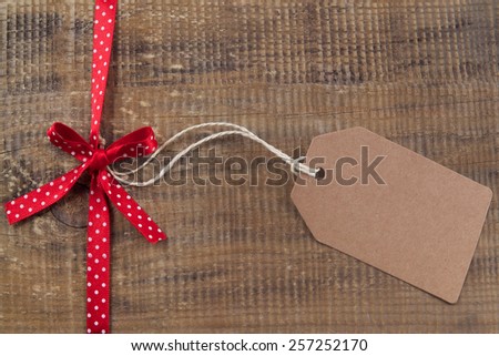 Ribbon with label on wooden background