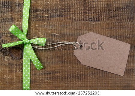 Ribbon with label on wooden background