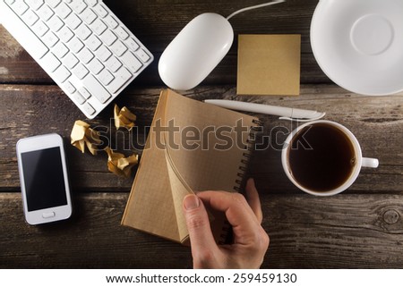 Table with business tools and hand