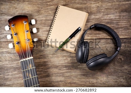 headphone guitar notebook and pencil
