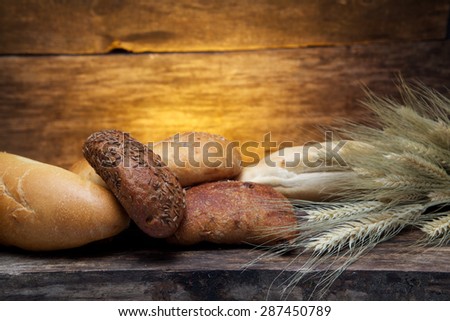 fresh bread  and wheat on the wooden background