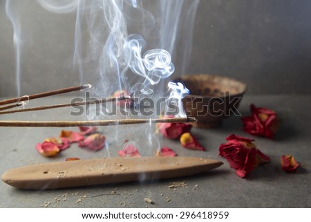 incense sticks with rose flowers leaves