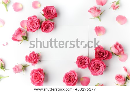 Framework from roses on white background. Flat lay.