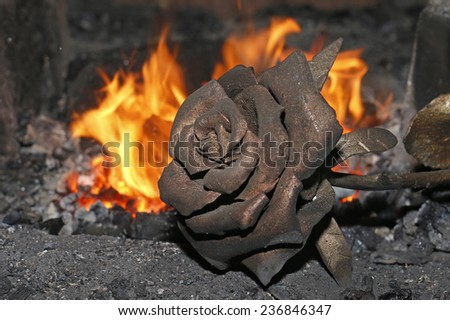 forged rose on a background of fire