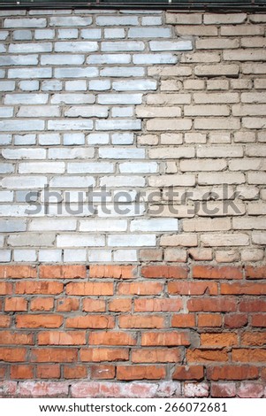 Grey and red brick wall background. Old bricks are replaced by new ones