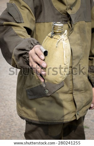 man in uniform with a flask in hand