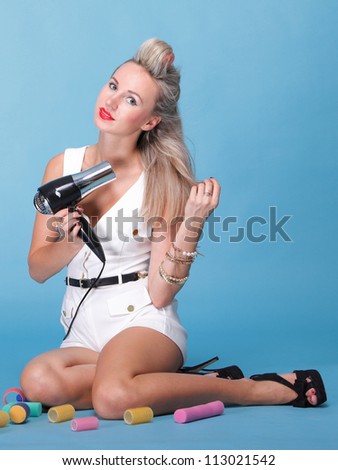 pin up girl retro style portrait woman drying hair with electric fan