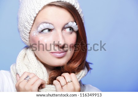 Beautiful winter young woman portrait with white eye-lashes eyelash hat violet