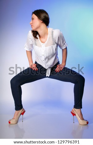Full body young plus size woman in casual clothes, relaxed pose studio shot blue background