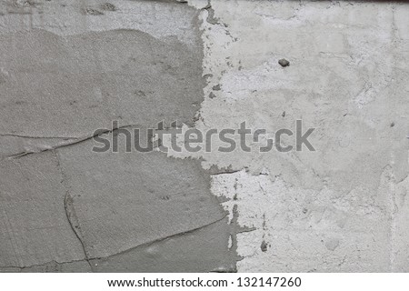 Construction worker is tiling at home, tile floor adhesive Abstract plaster stucco wall