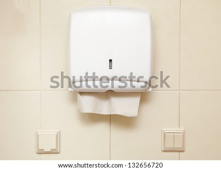 Paper towel dispenser on the wall in the bathroom