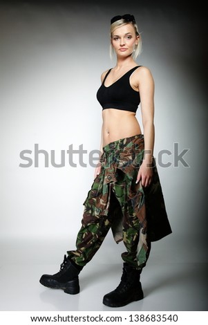 woman in military clothes army girl on gray background.