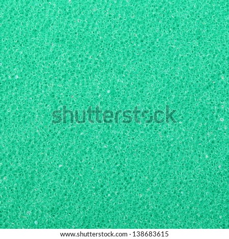 Green texture cellulose foam sponge - background. Square format