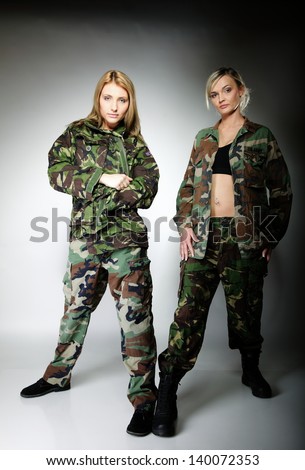 Full length two women in military clothes army girls on gray background.