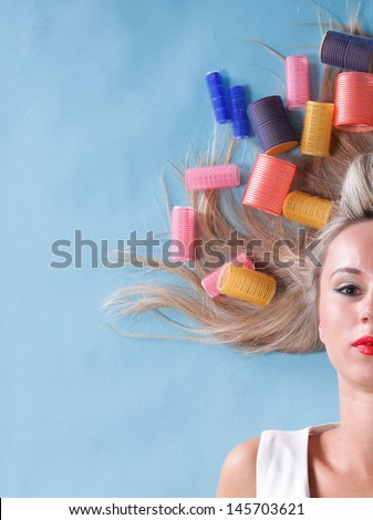 pin up girl retro style portrait woman drying hair with curl-papers hair curlers