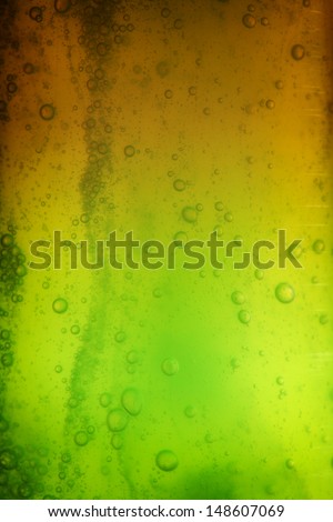 Green brown abstract blurred liquid background with soap bubbles