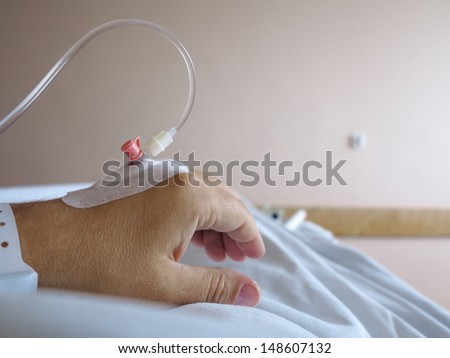 Arm of a male patient in the hospital with an iv intravenous drip - health, emergency.