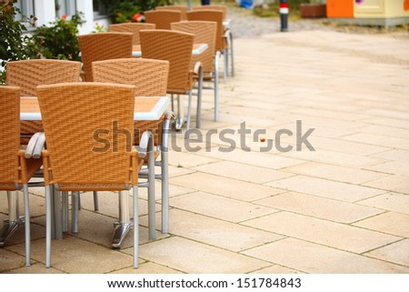 Outdoor restaurant coffee terrace open air cafe chairs with table. Summer vacation on resort