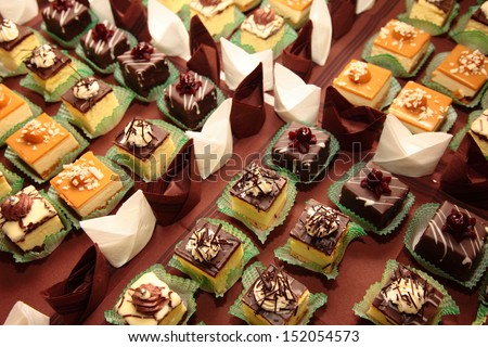 Varieties of cakes individual decorative desserts on the table at a luxury event, gourmet catering sweets