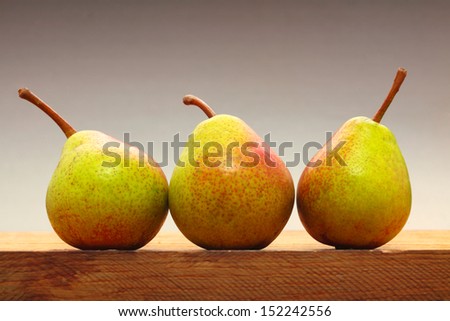 Three pears fruits on old wooden table. Healthy food organic nutrition