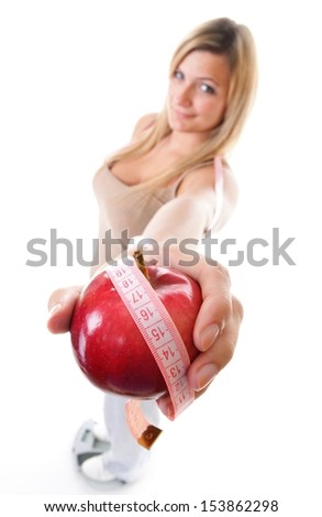 Time for diet slimming. Woman plus size large girl on scale with apple measuring tape - weight loss concept. Isolated on a white background.