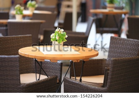 Outdoor restaurant open air cafe chairs with table