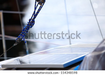Solar charging batteries aboard a sail boat. Photovoltaic panels renewable eco energy concept