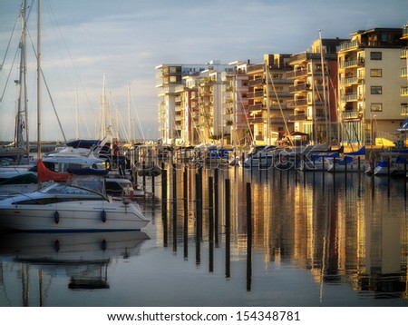 MALMO, SWEDEN - AUGUST 7 : Yachts and modern houses in marina on August 7, 2013 in a gulf of Malmo, Sweden.