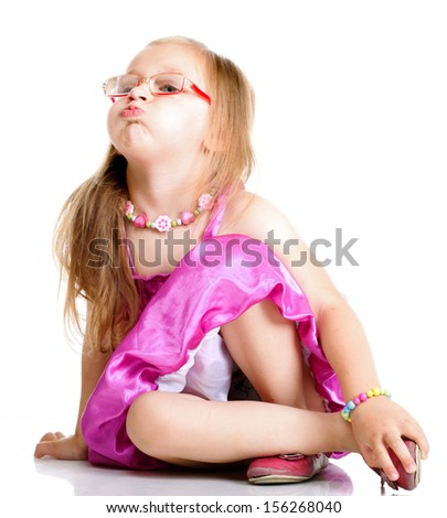 Full length a cute girl sitting on floor puffs up her cheeks on white background