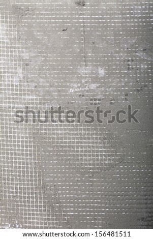 Improvement renovation at home. Construction site tile adhesive reinforcement mesh on floor grunge background texture