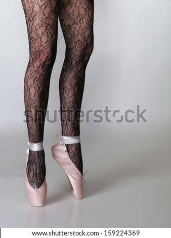 beautiful woman ballet dancers legs gray background