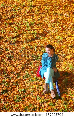 Young  thoughtful pensive woman outdoor, sad unhappy girl thinking in the autumn park. Loneliness stress depression.