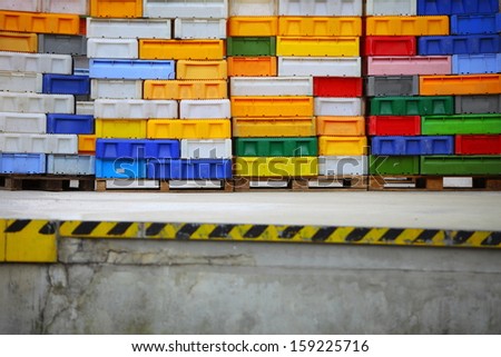 colorful boxes plastic crates. Packing containers piles for fish storage of catch.
