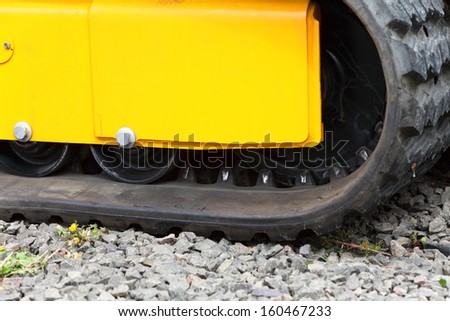 Tracks of small digger excavator heavy equipment industrial detail
