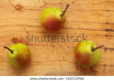 Three pears fruits on old wooden table background. Healthy food organic nutrition