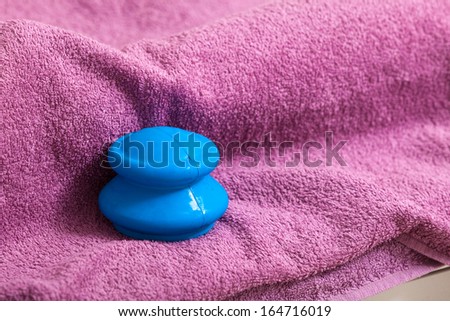 Blue rubber cupping glass on pink towel for vacuum massage therapy, traditional chinese medicine. Alternative medical procedure,