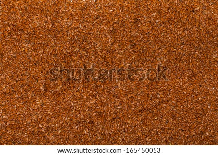 Close up of flaxseed linseed as brown red food background or grain texture. Diet and nutrition.