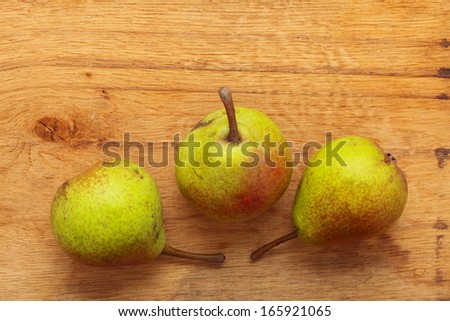 Three pears fruits on old wooden table background. Healthy food organic nutrition