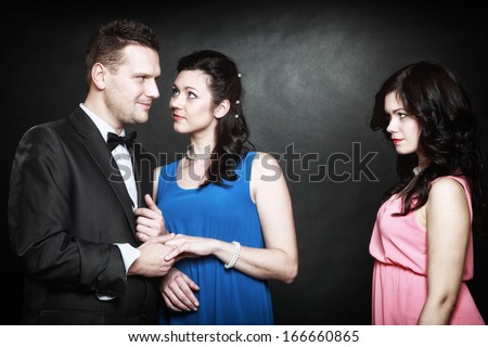 Marital Infidelity Concept. Love Triangle Two Women One Man Passion Of Love Hate. Mistress Betrayal Within The Family. Black Background