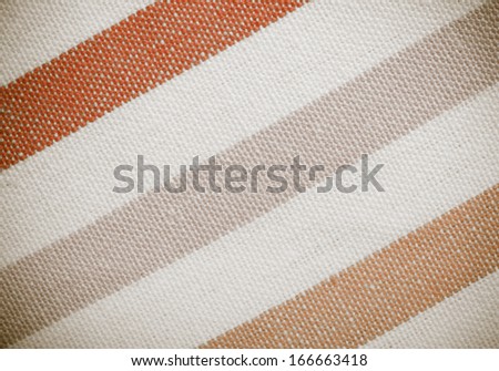 Closeup of colorful pink violet white diagonal striped fabric textile as background texture or pattern. Macro.