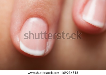 Close up of female hand with french manicure, part of palm human fingers