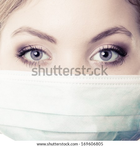 Closeup of woman in green face mask. Doctor or nurse isolated. Safety in risk work.