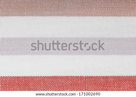 Closeup of colorful pink white horizontal striped fabric textile as background texture or pattern. Macro.