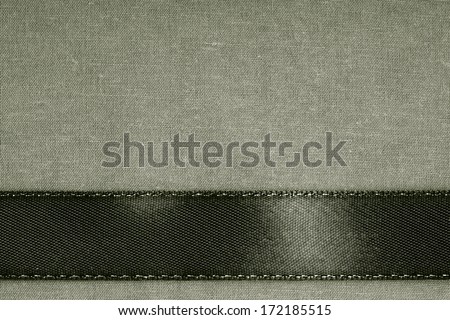 vintage background. Black ribbon on gray fabric cloth texture with copy space.